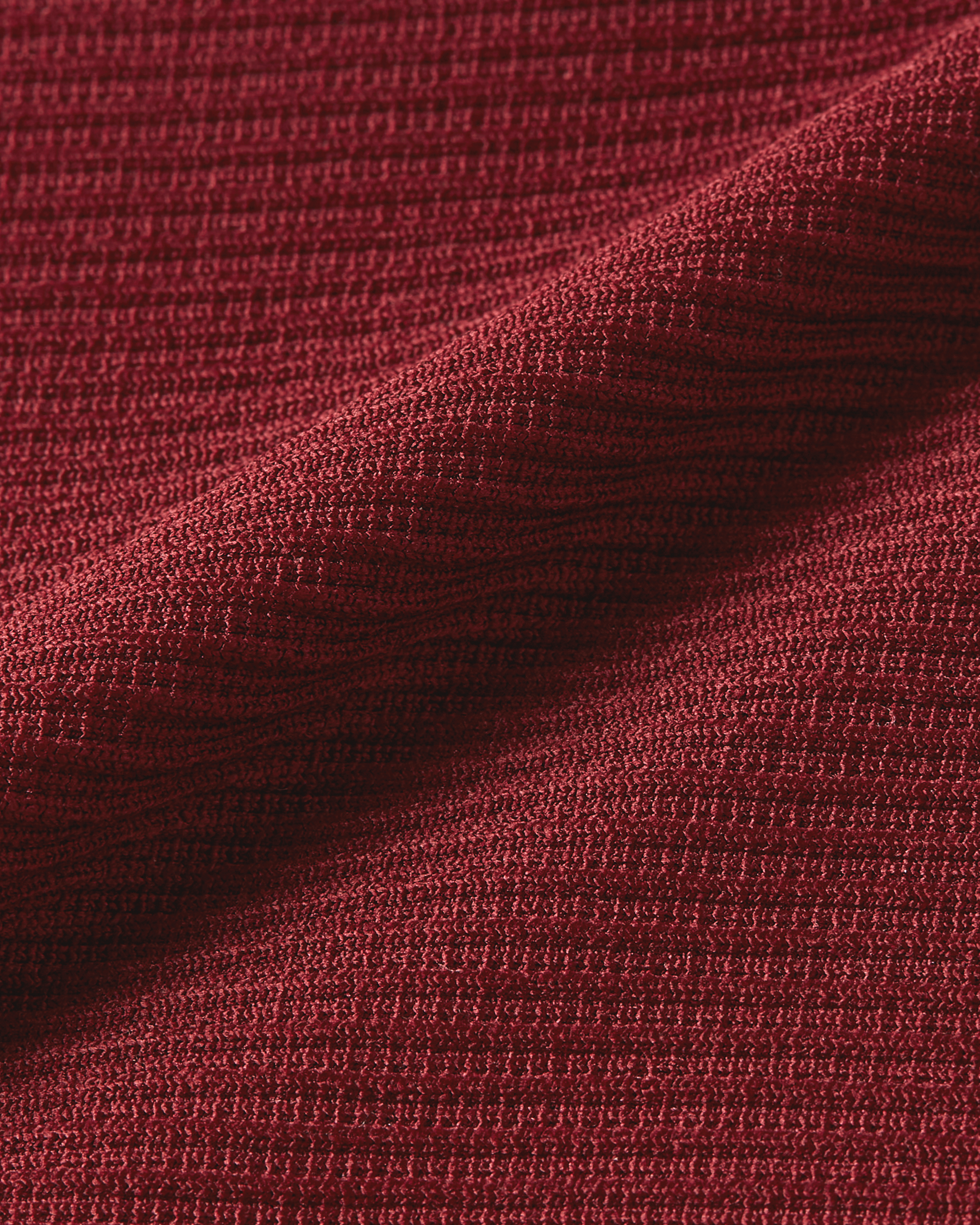 Detail product image of bordeaux bodysuit focusing on ribbed lines and fabric that adapts smoothly to the body