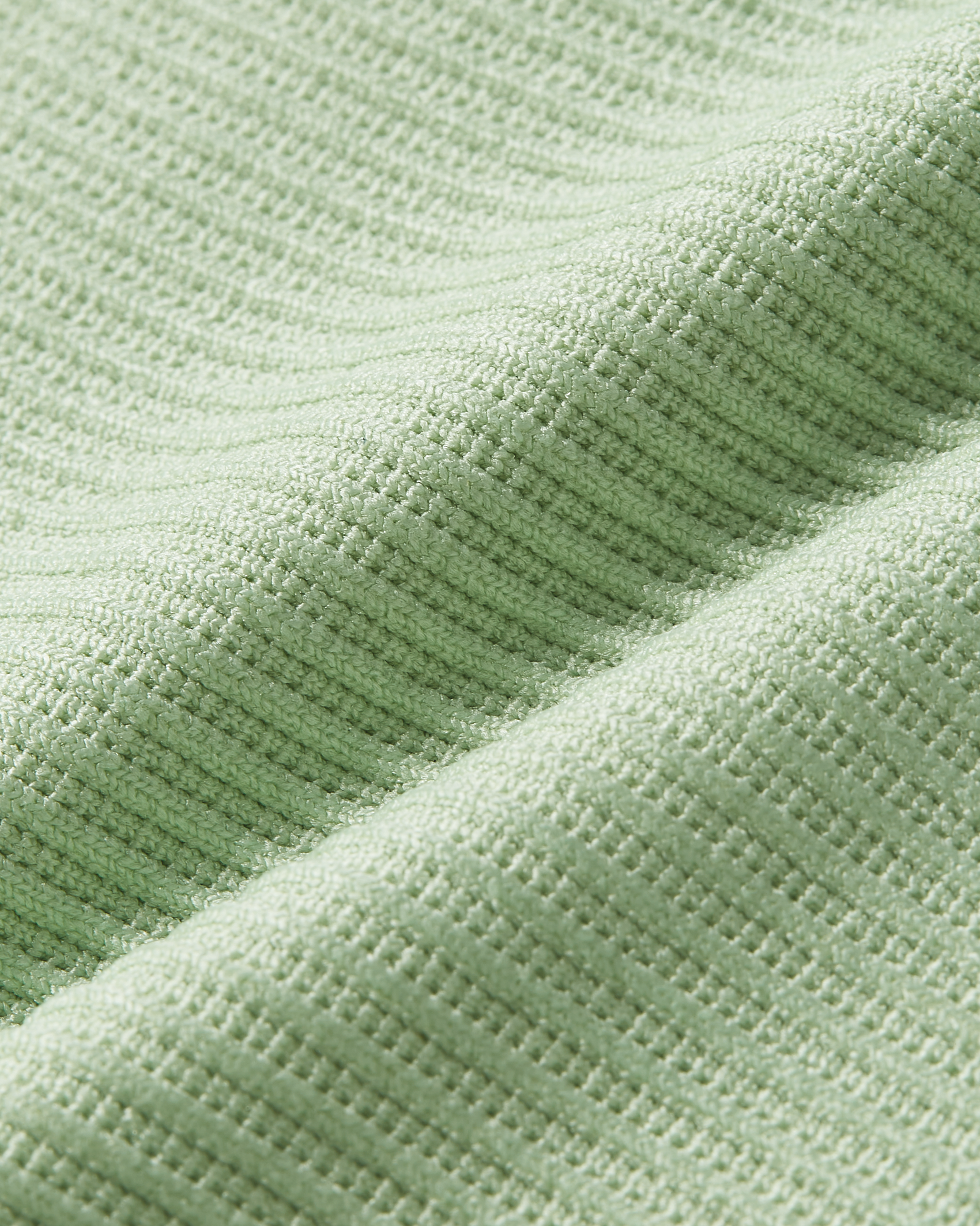 Detail product image of matcha bodysuit focusing on ribbed lines and fabric that adapts smoothly to the body