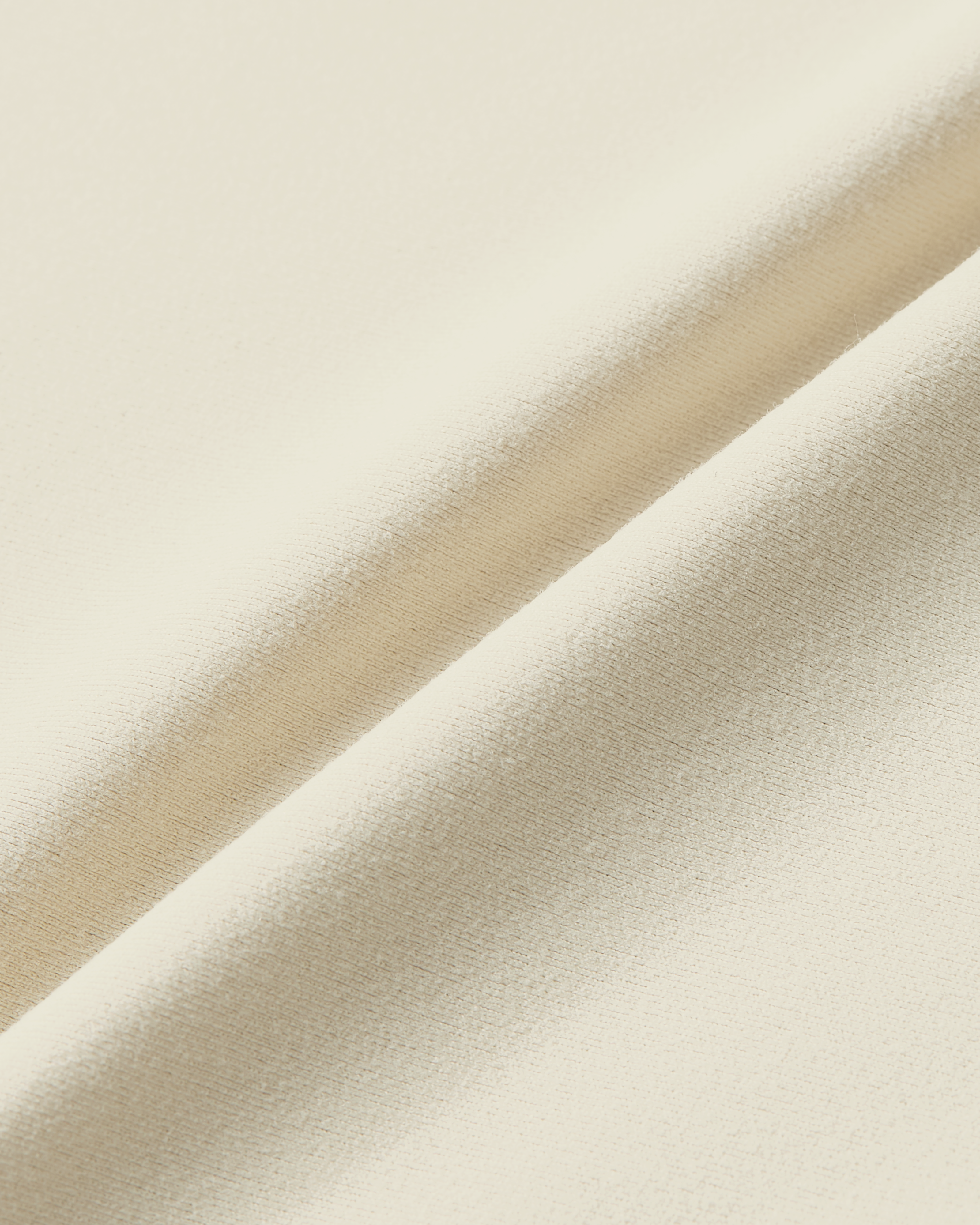 Close-up product photo of beige soft skin fabric with soft touch and natural smooth texture