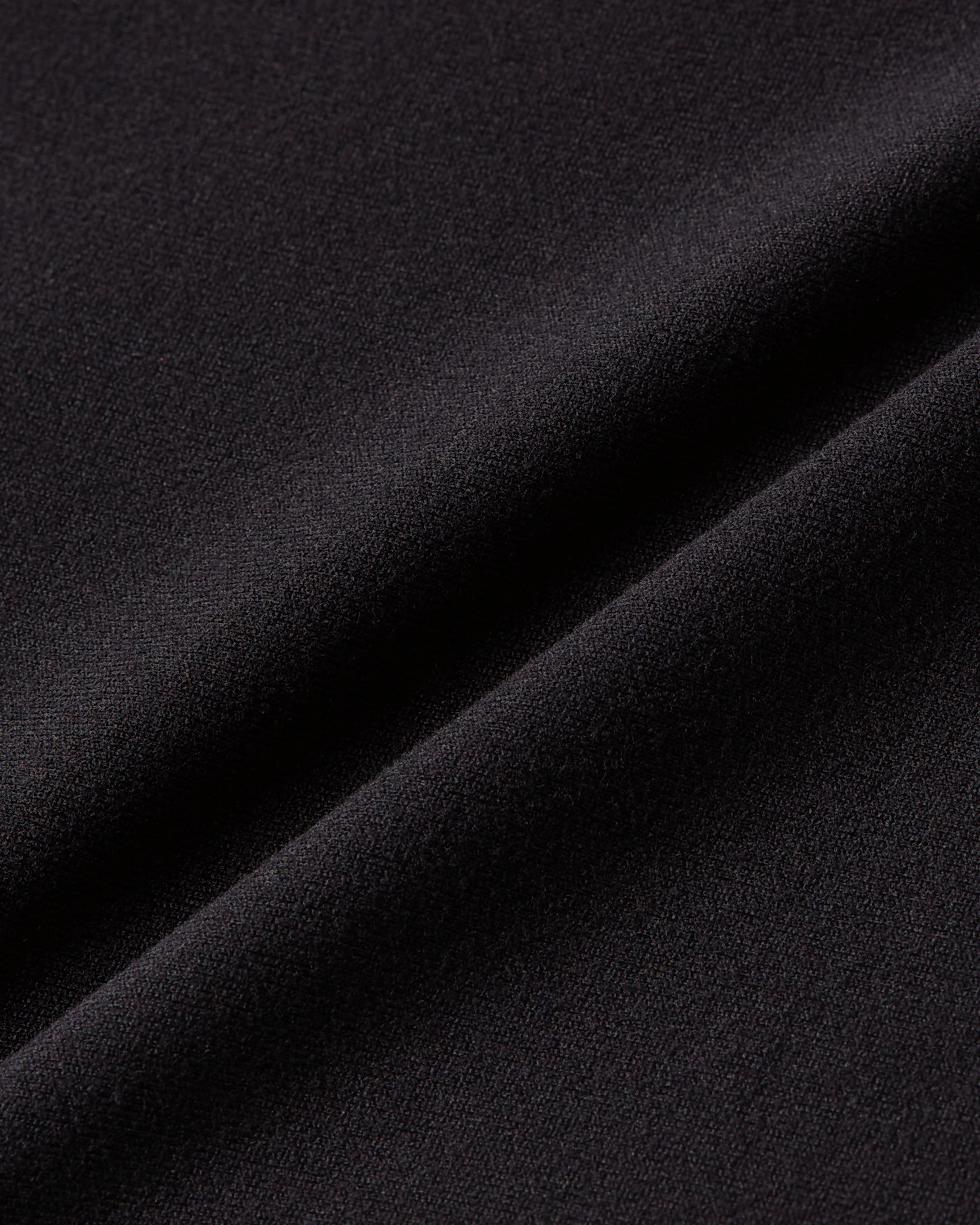 Close-up product photo of black soft skin fabric with dense smooth texture and sculpting stretch