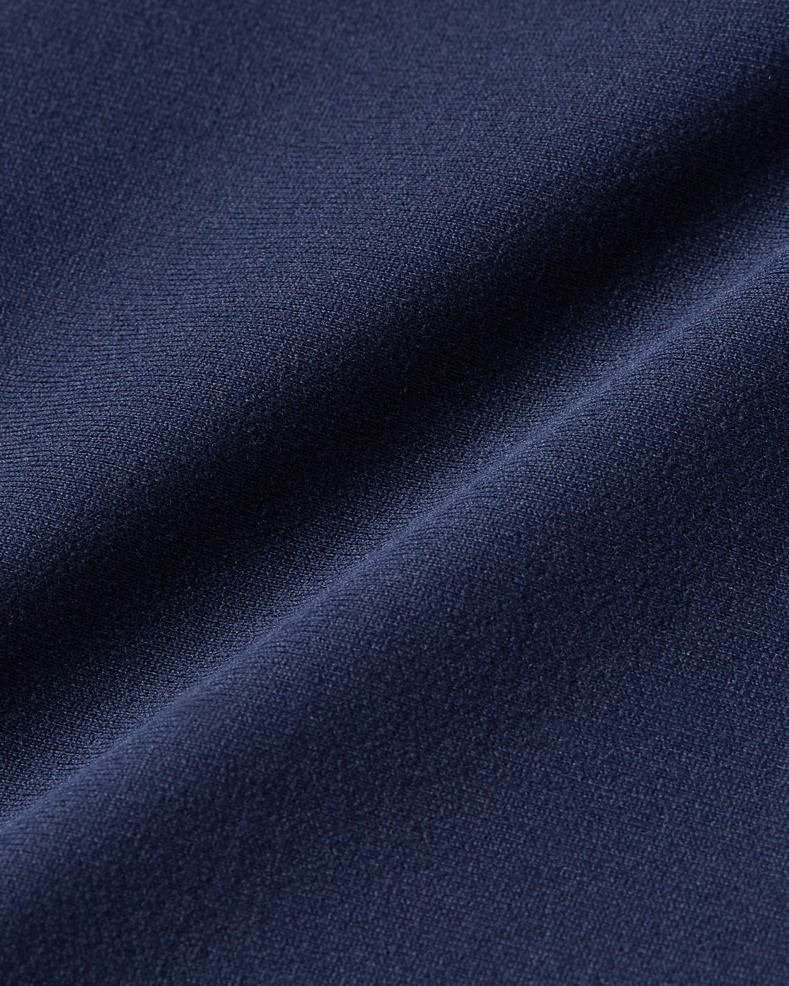 Navy fabric detail image showing lightweight material with a flexible second skin feel