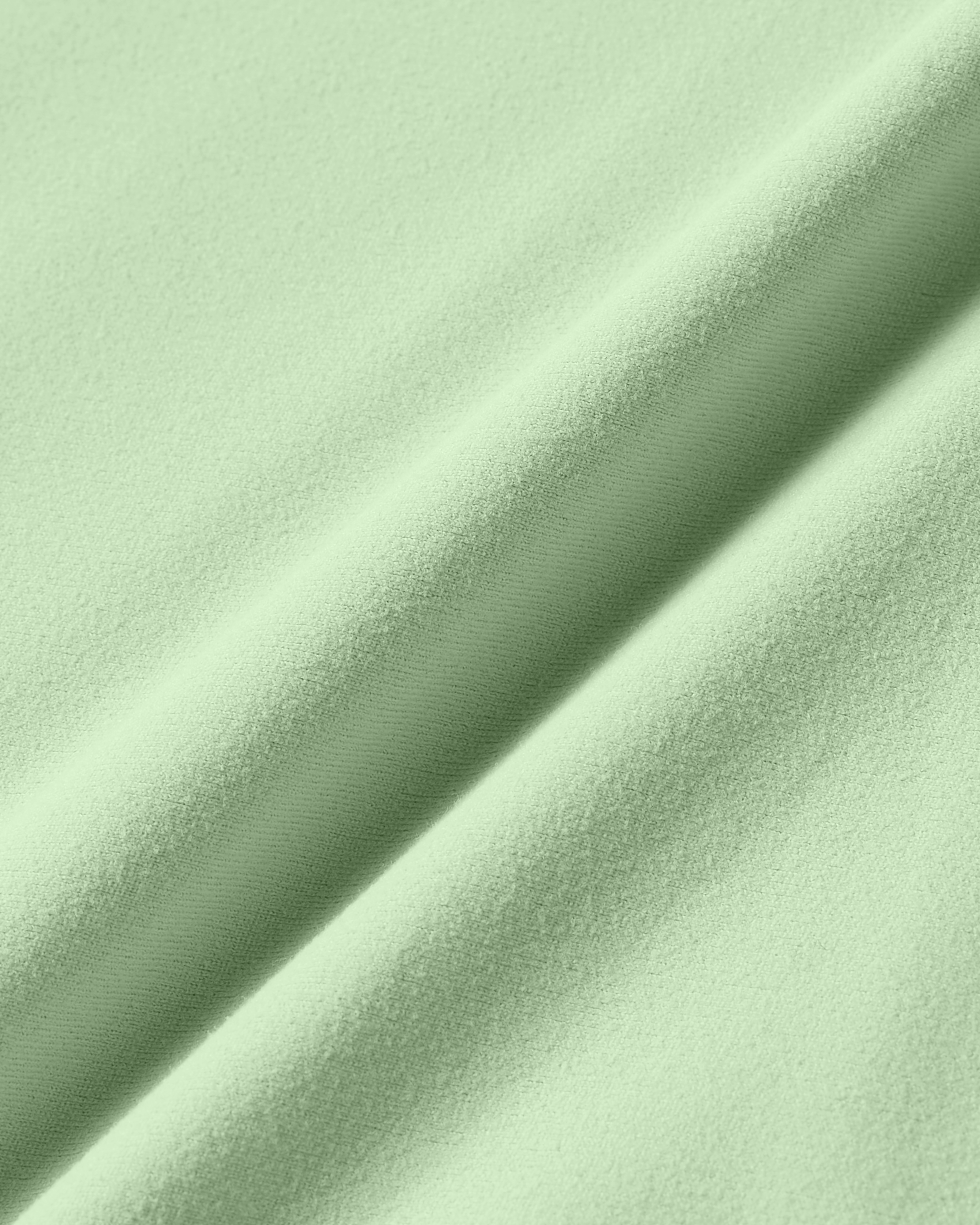 Close-up product photo of matcha soft skin fabric with silky texture and fluid stretch