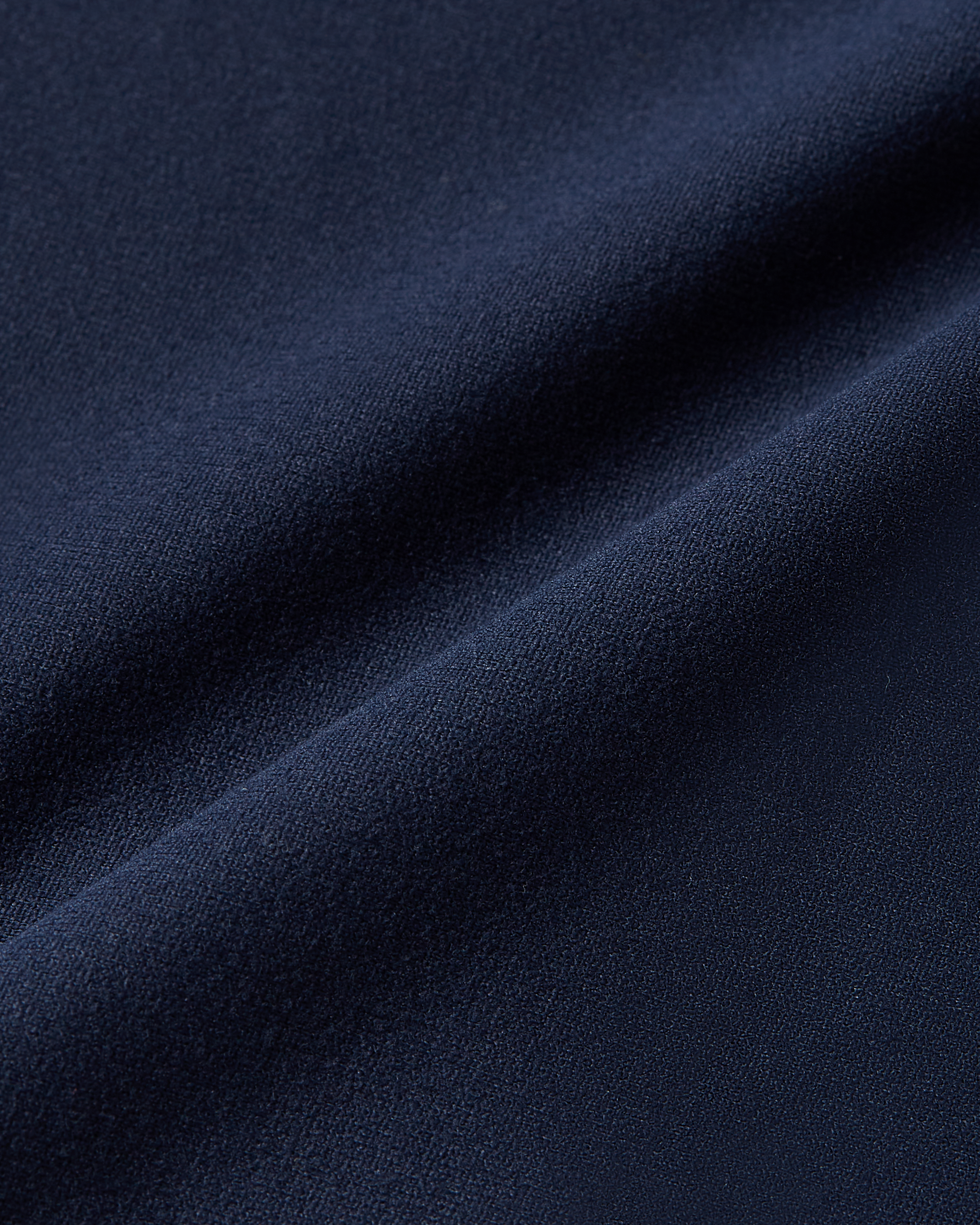 Detailed image of navy bodysuit fabric showing breathable elastic material and second skin feel