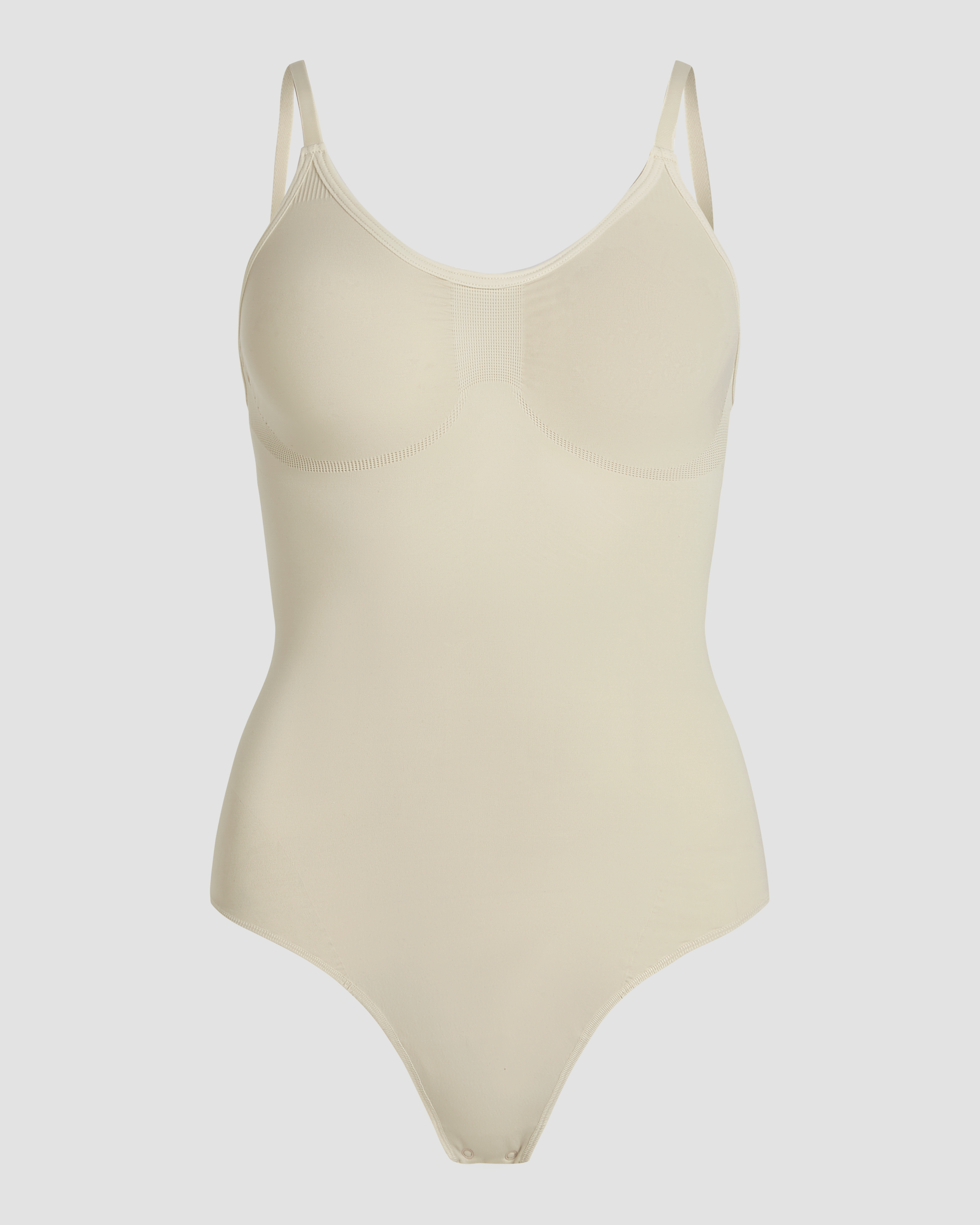 Detailed product photo of beige shapewear bodysuit thong with firm support and smooth finish