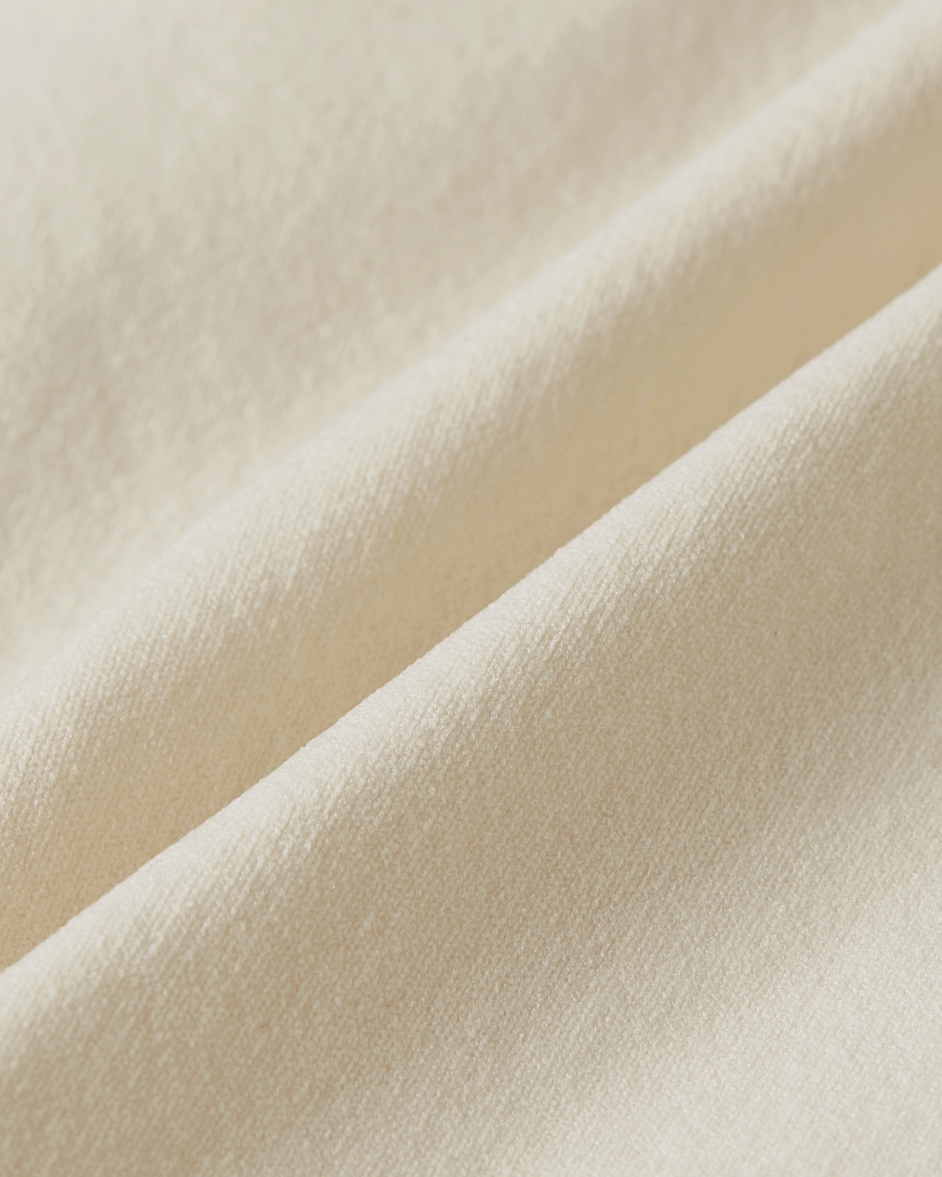 Fabric detail of beige seamless brazilian focusing on a refined texture with subtle elasticity and a clean, minimal finish