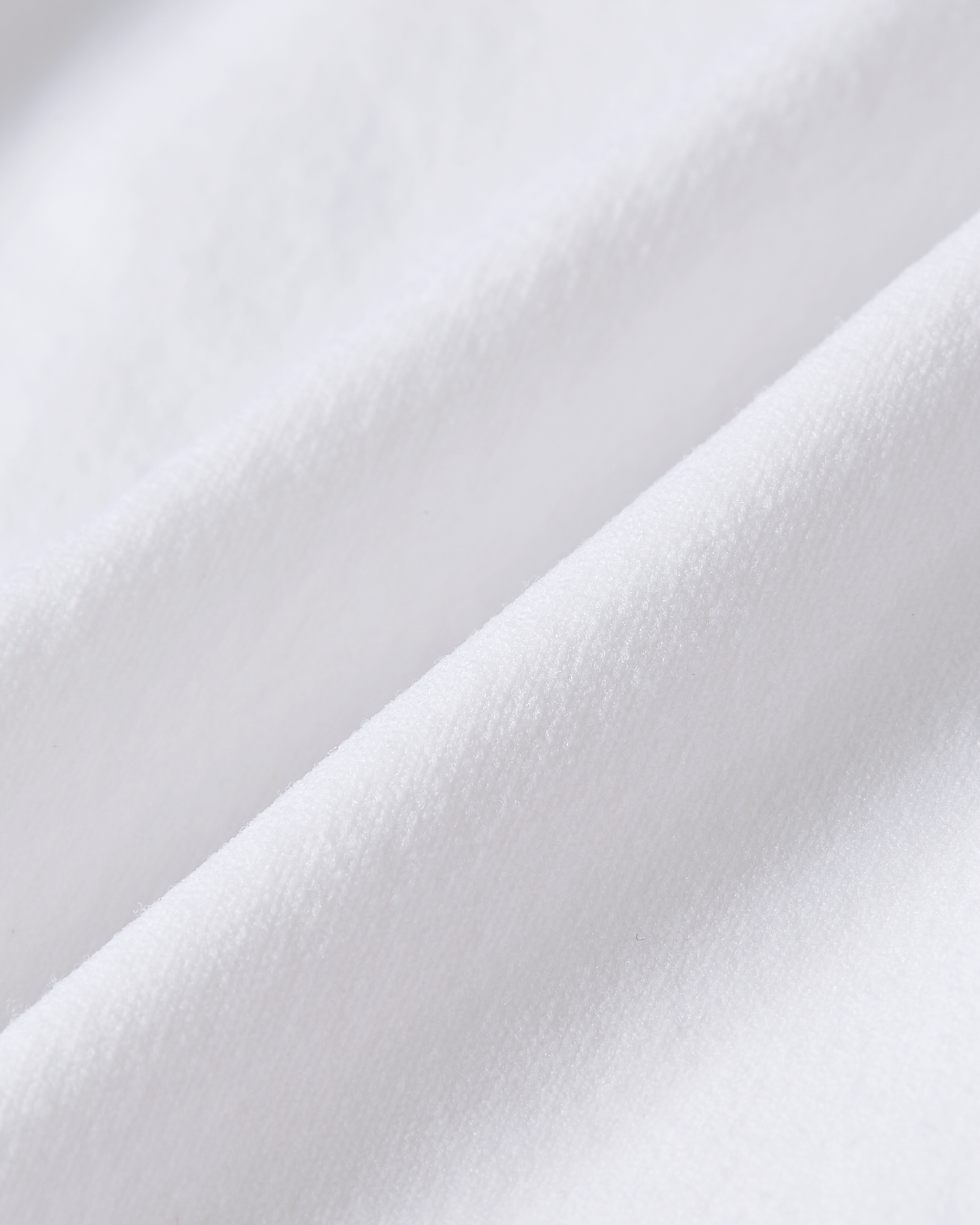 Detail product image of white brazilian underwear showing a smooth fabric surface with a clean tone and a soft, even texture
