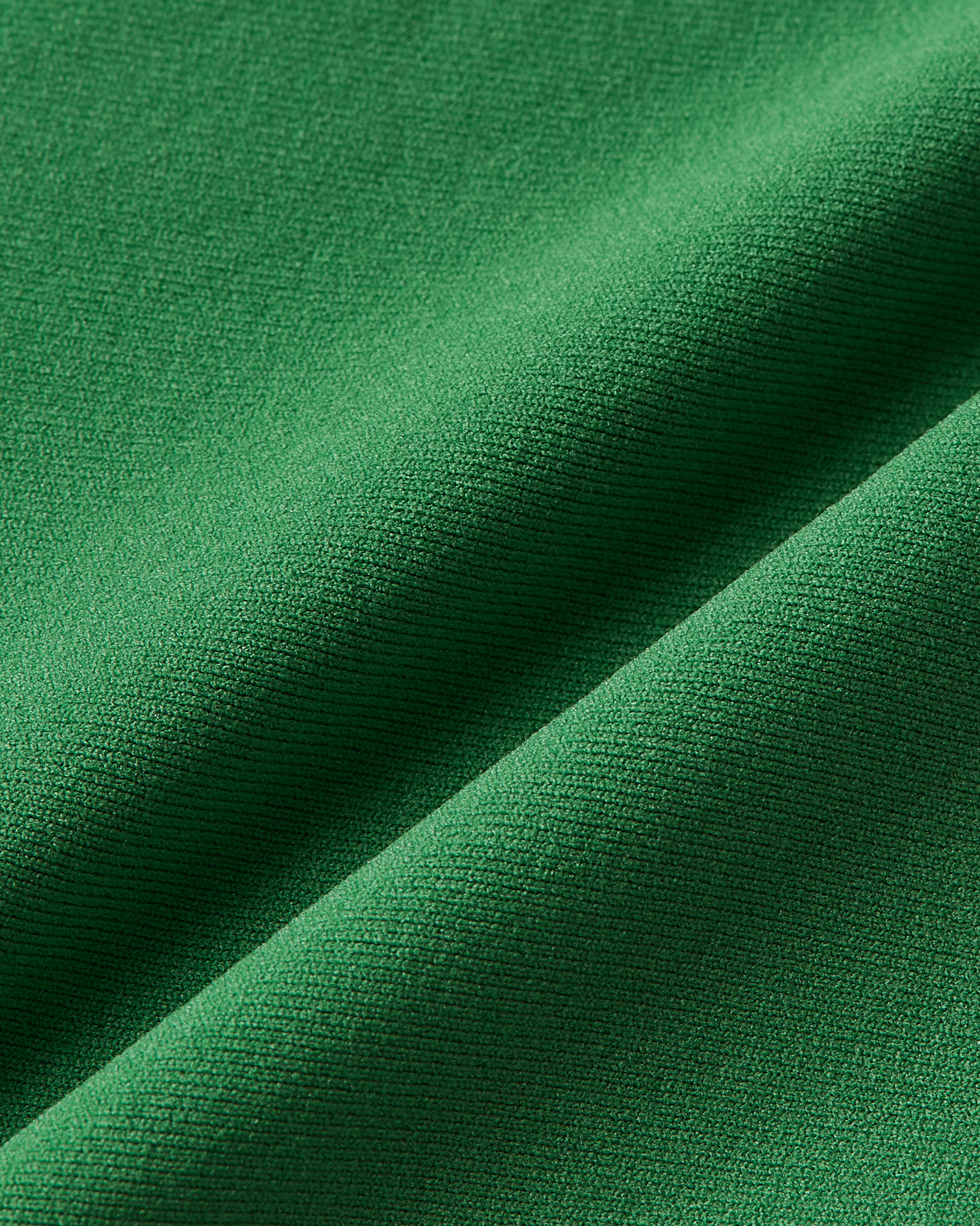 Close up of green tank highlighting lightweight material with a gentle stretch and a comfortable feel on the skin