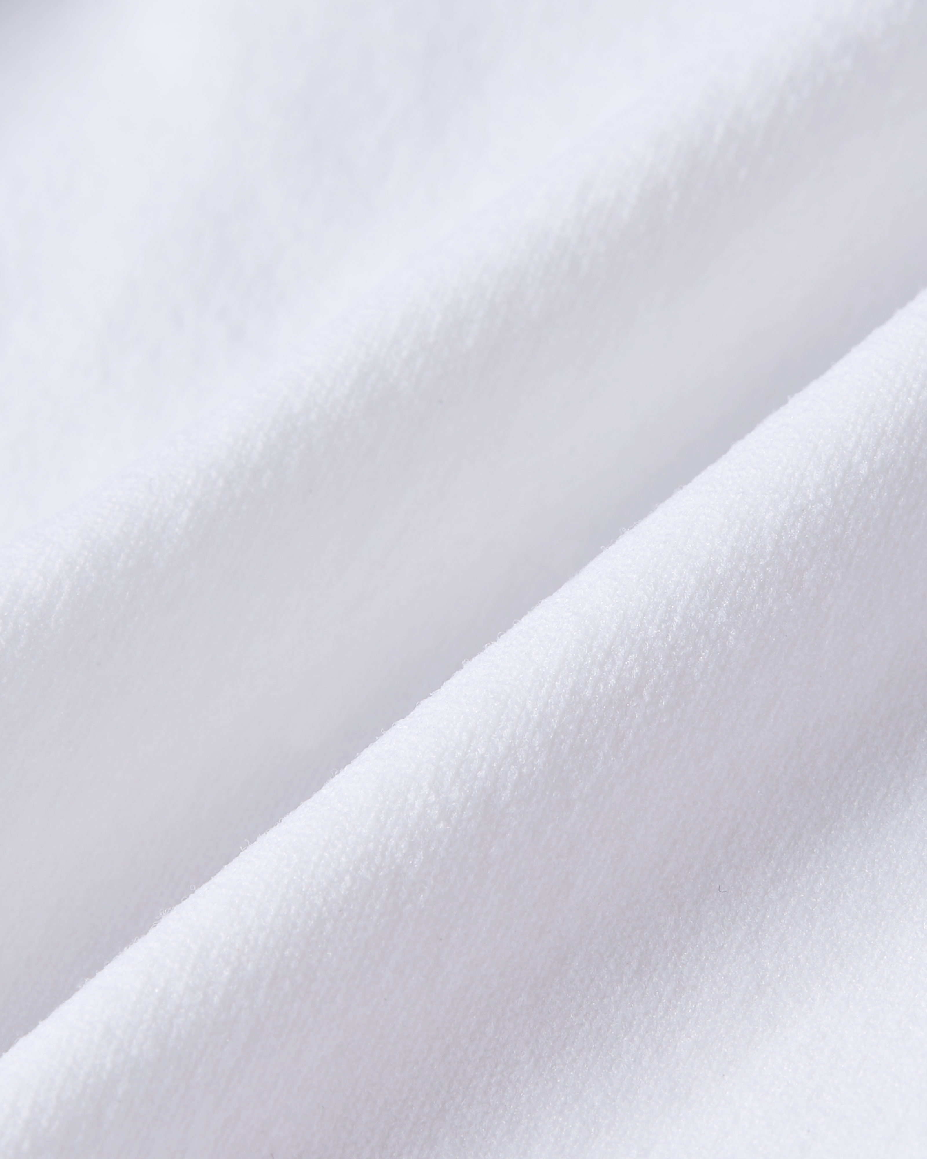 Detailed view of white thong fabric with a pure and smooth appearance designed for a barely visible look under clothing