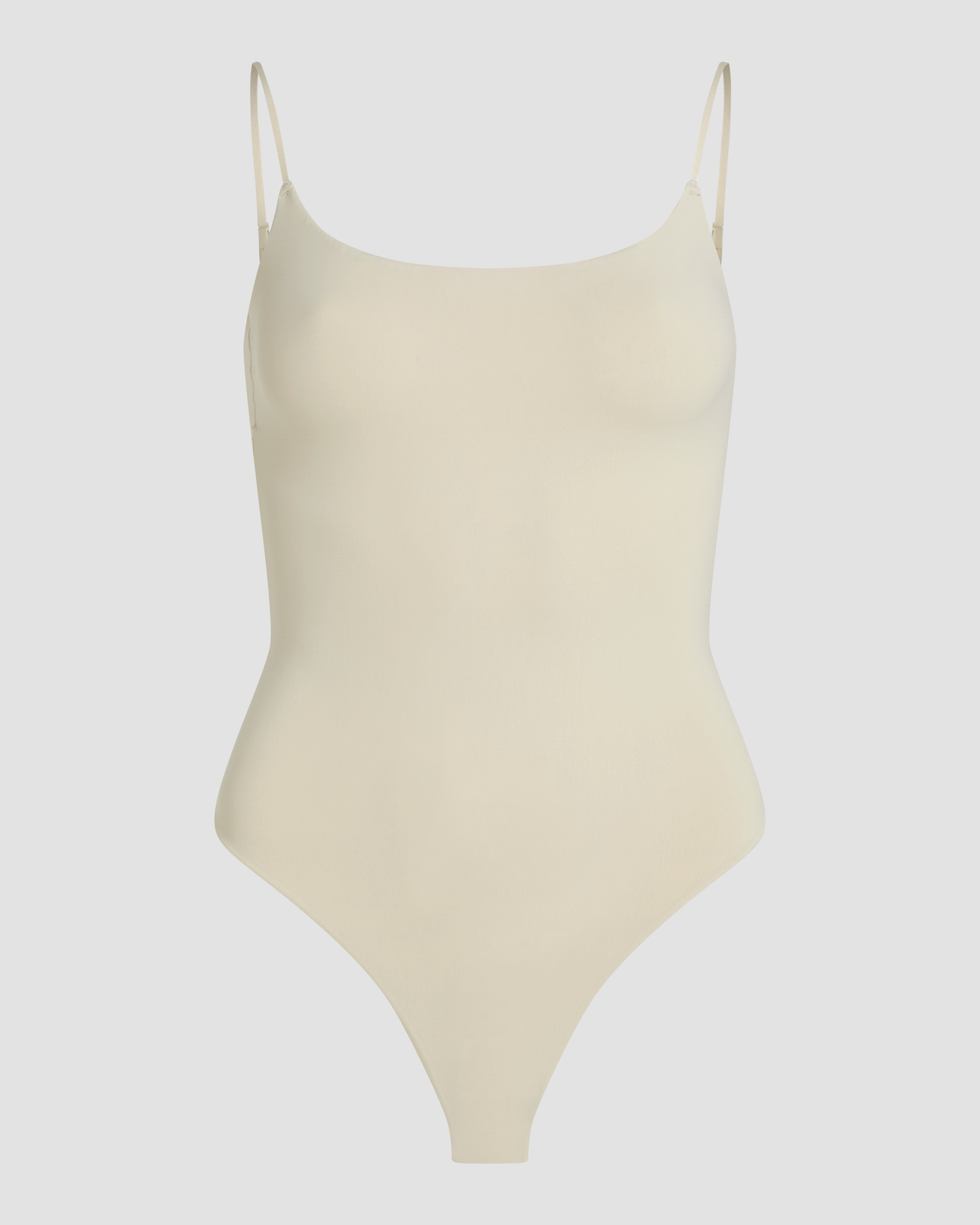 Seamless beige spaghetti strap bodysuit thong product photo with second skin fit