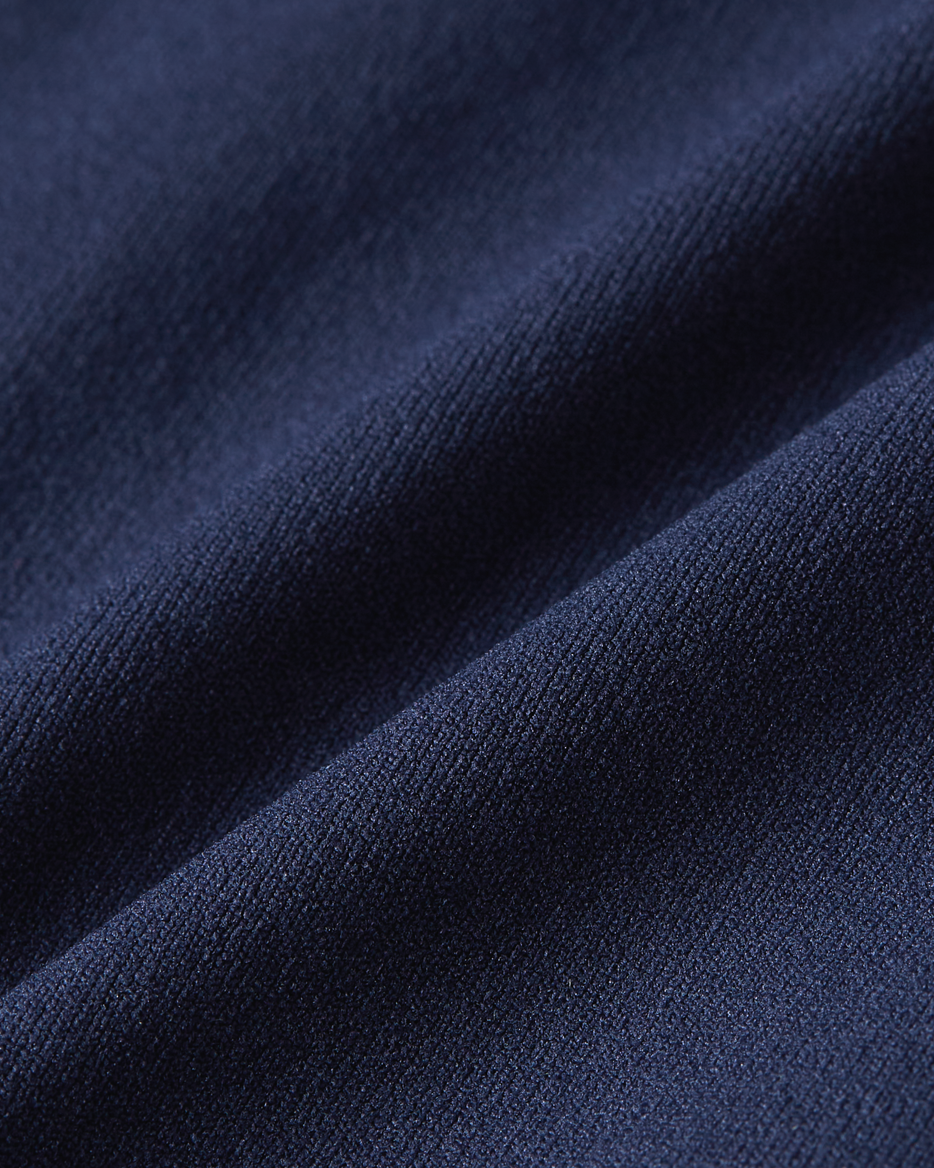 Close-up of dark blue Essentials brief fabric, showcasing the deep navy shade, sleek texture and comfortable stretch of the material