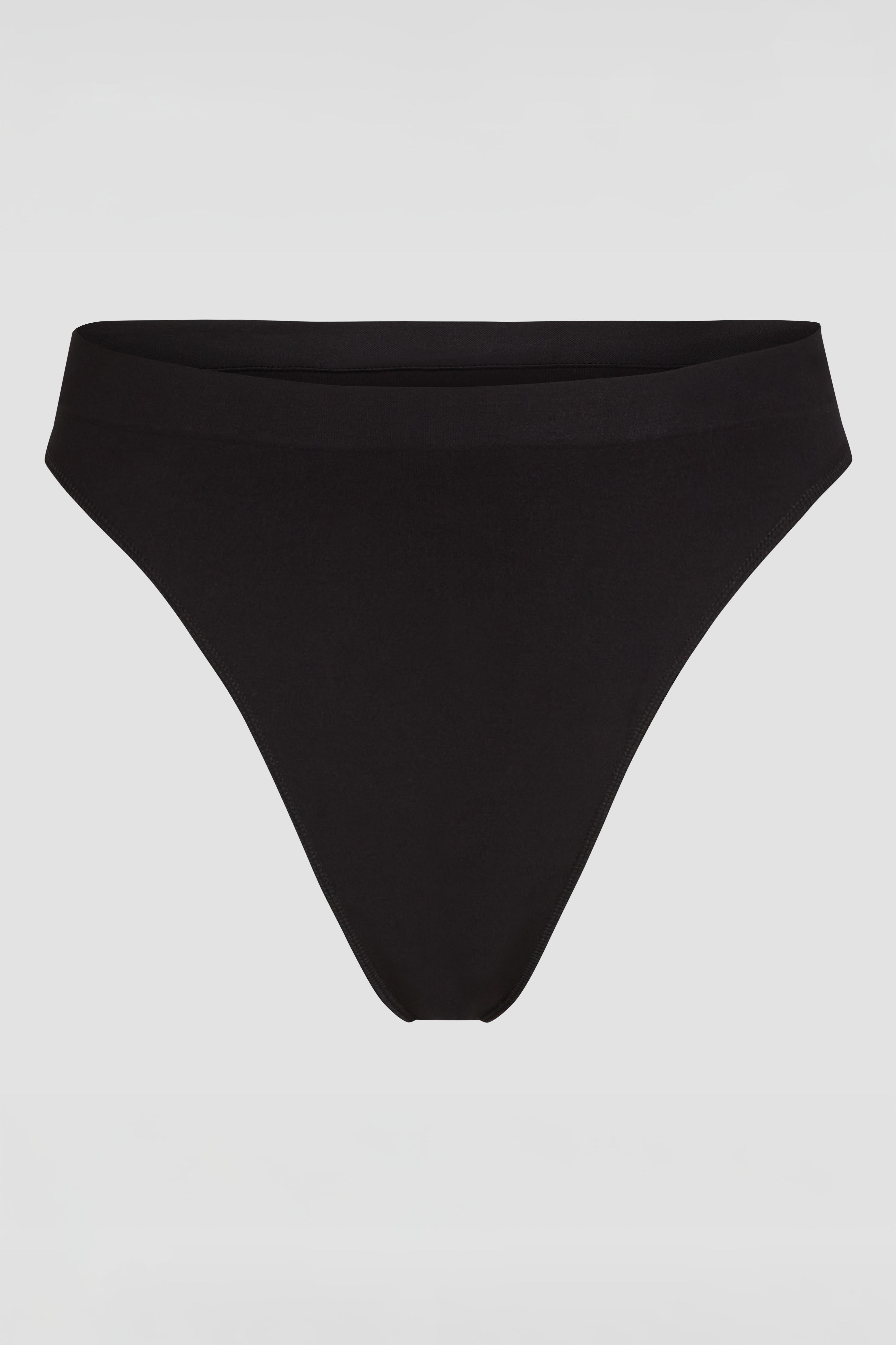 Black seamless shapewear thong product photo with smoothing effect under clothing