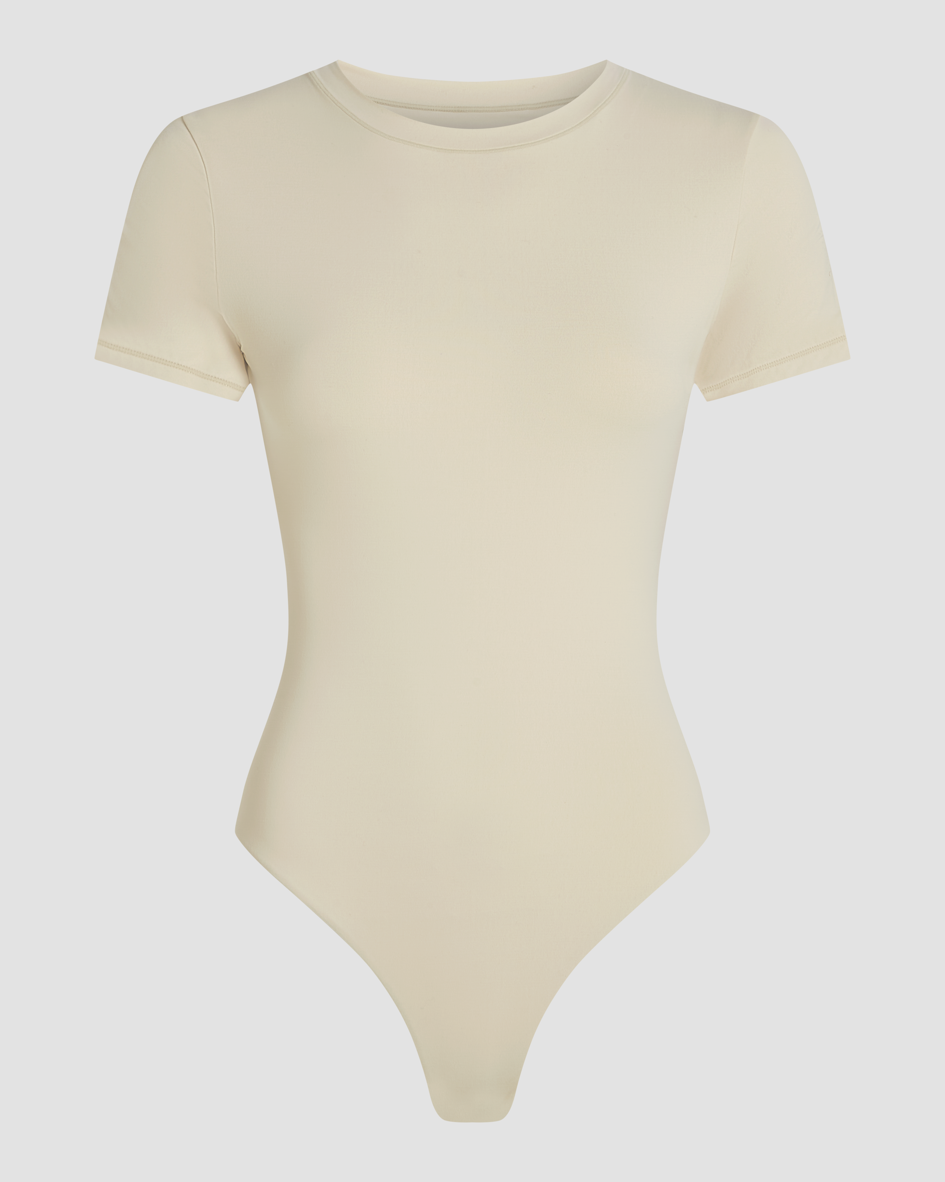 Seamless beige bodysuit shown in product photo with short sleeves and natural shape